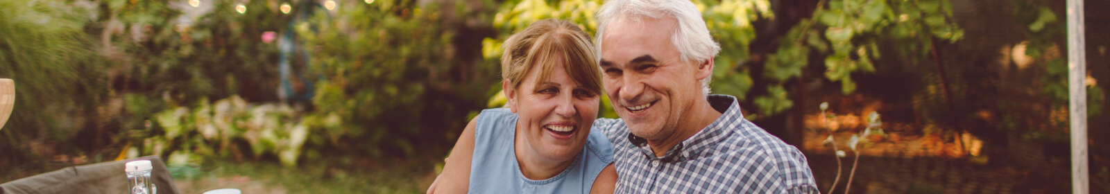 middle-aged couple sitting outside