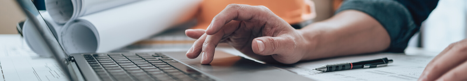 close-up of hands using a laptop