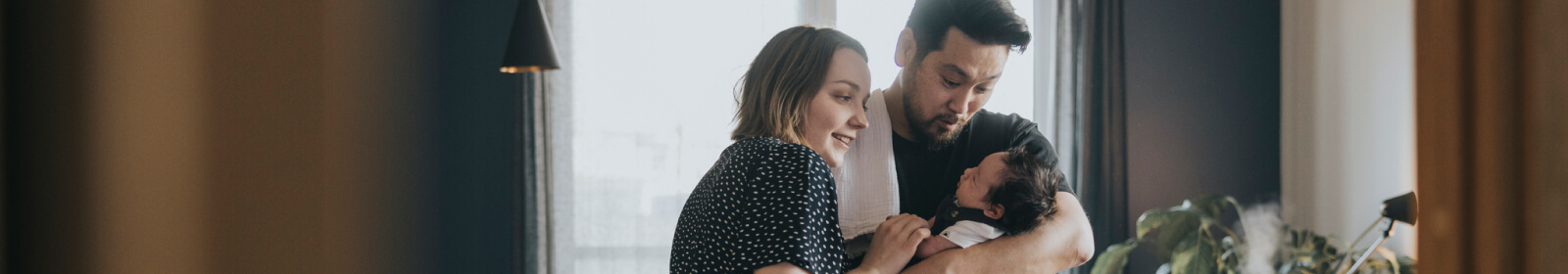 young couple holding a new born baby